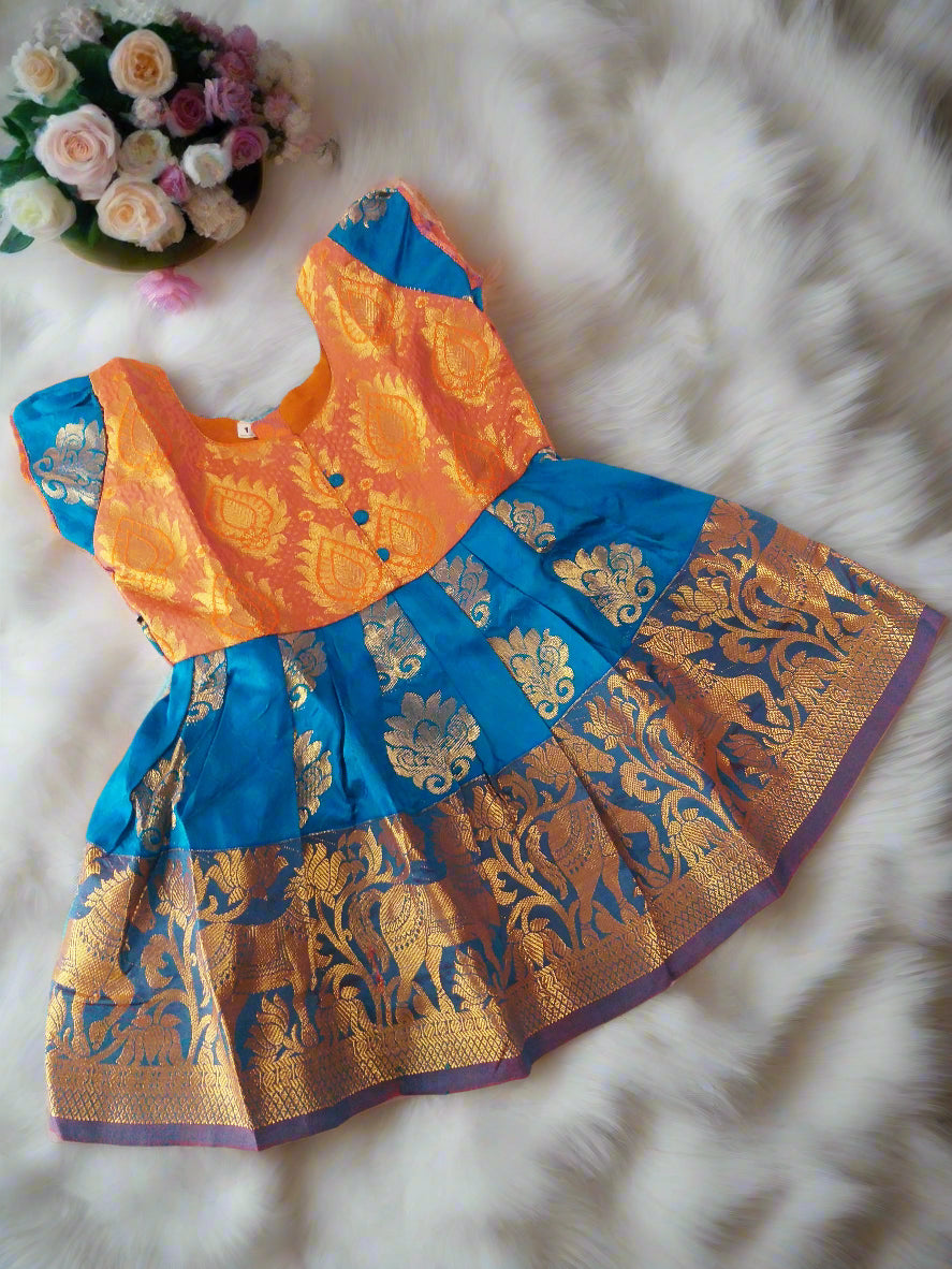 Green and gold pattu silk frock for baby girls with embossed puff sleeves – traditional Indian kids dress