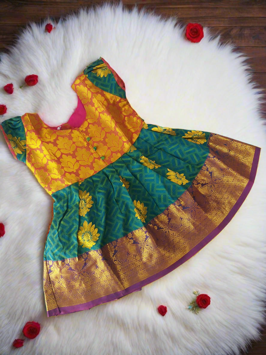 Green and gold pattu silk frock for baby girls with embossed puff sleeves – traditional Indian kids dress