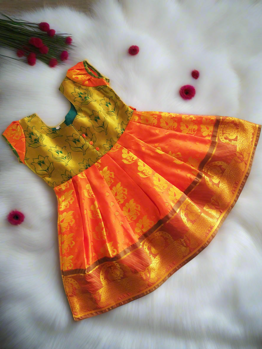Green and gold pattu silk frock for baby girls with embossed puff sleeves – traditional Indian kids dress