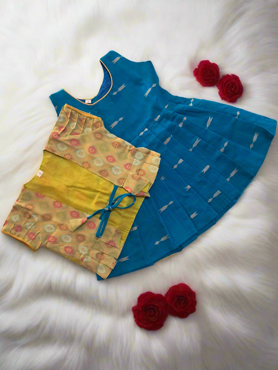 Shop this Sky Blue frock with golden arrow motifs and Pista Green brocade jacket for girls. A perfect ethnic outfit for parties, weddings, and festivals
