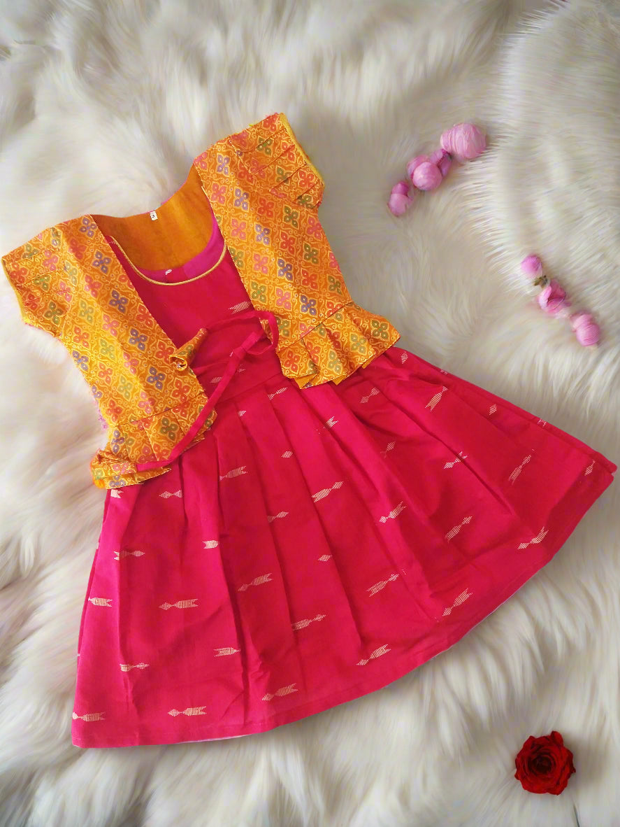 Shop this Rani Pink frock with golden arrow motifs and Mustard brocade jacket for girls. A perfect ethnic outfit for parties, weddings, and festivals