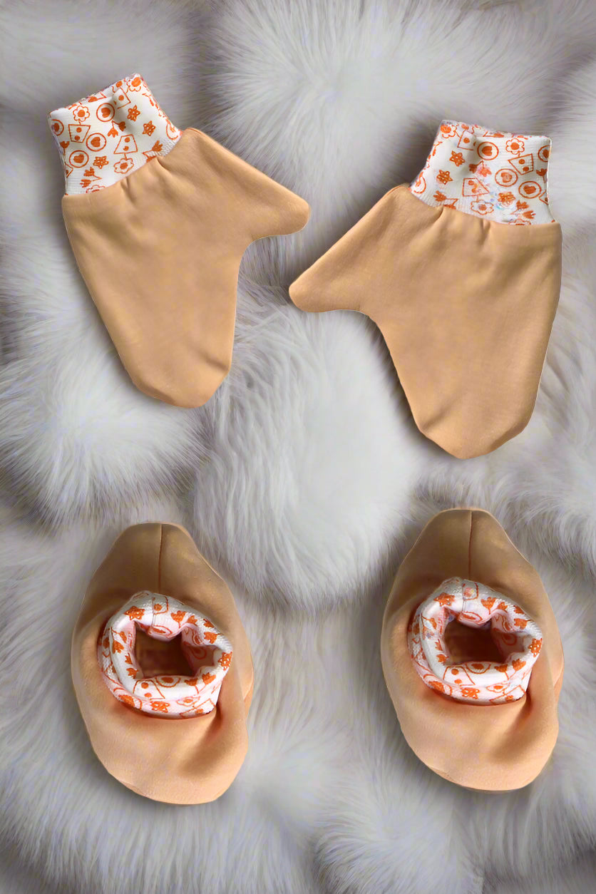 Soft cotton newborn baby mittens and booties set in Peach color for 0–6 months with printed elastic bands