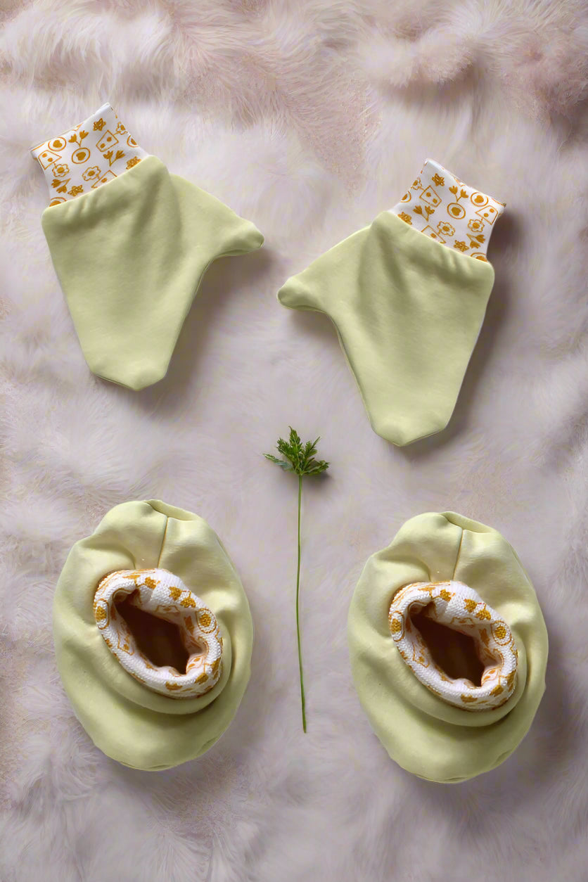 Soft cotton newborn baby mittens and booties set in yellow color for 0–6 months with printed elastic bands