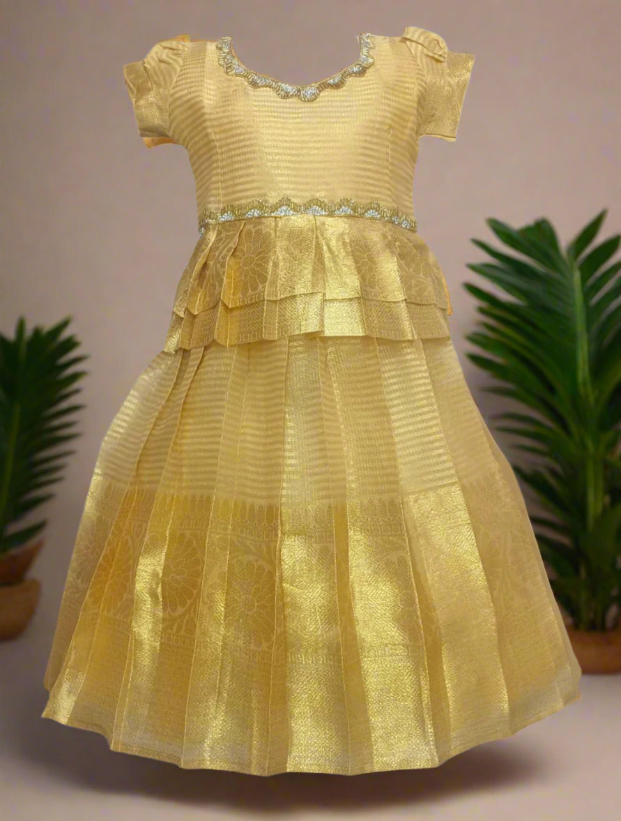 Golden pleated silk pattu frock for girls with zari border and layered waist design