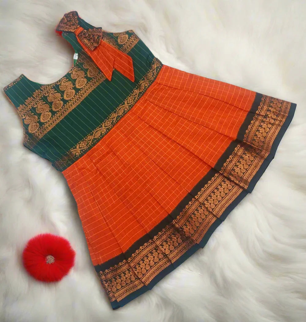 Baby girls silk frock featuring rich silk fabric with elegant zari border, puff sleeves, and traditional design in vibrant festive colors – perfect ethnic wear for infants and toddlers for weddings, naming ceremonies, birthdays, and cultural events