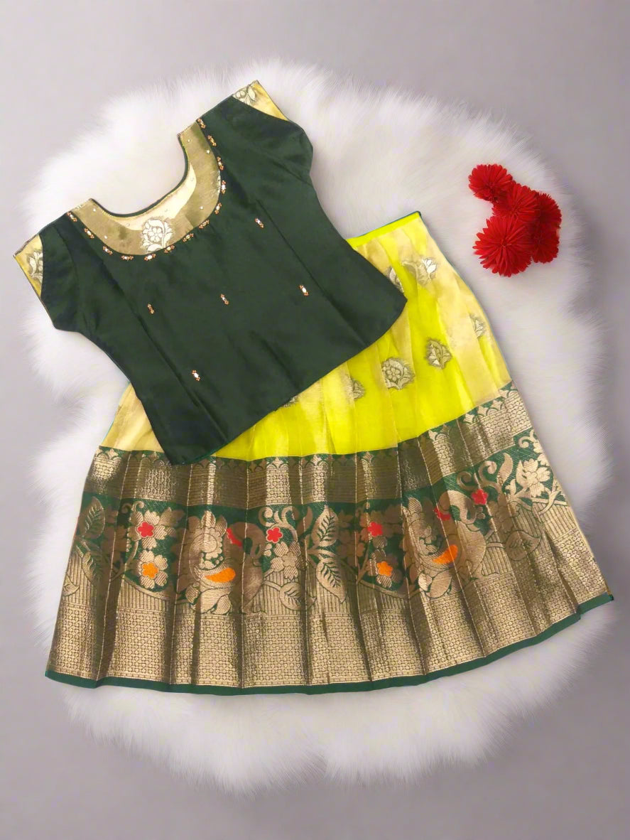 Traditional outfit with green blouse and yellow skirt on a white background