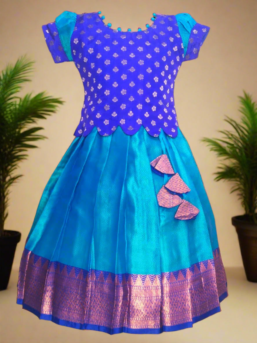 Girls Blue Banarasi muslin pattu pavadai with scallop hem top, potli ball neck design, and tassels – ethnic kids festive wear