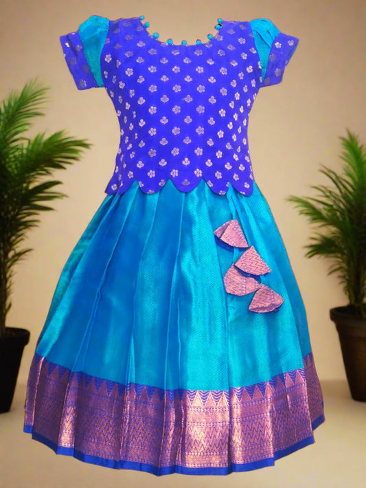 Girls Blue Banarasi muslin pattu pavadai with scallop hem top, potli ball neck design, and tassels – ethnic kids festive wear
