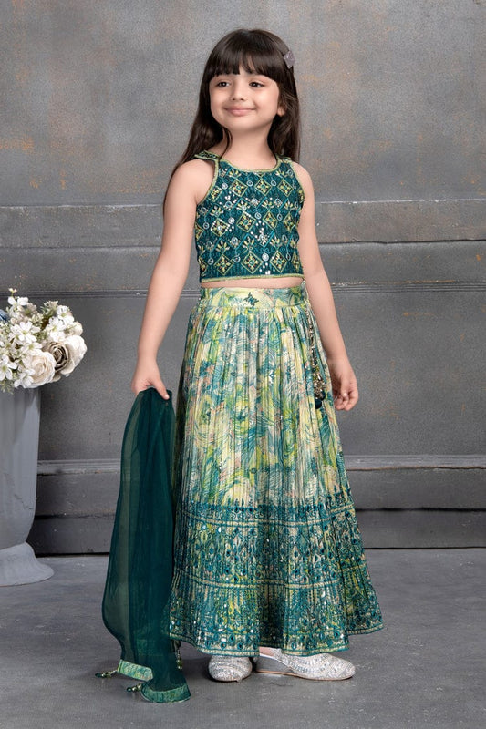 Little girl in green mirror work lehenga choli set with matching dupatta – Indian kids festive outfit.