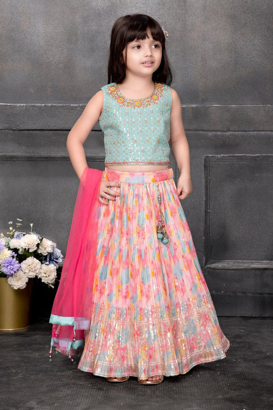 Little girl wearing a designer floral lehenga choli set with sequins and a pink dupatta – festive kids ethnic wear.
