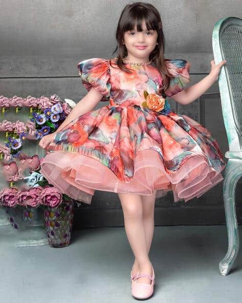 Peach floral printed party frock for baby girls with puff sleeves and layered net – perfect for birthdays and weddings.