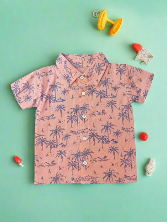 Pink shirt with purple palm tree pattern on a white background