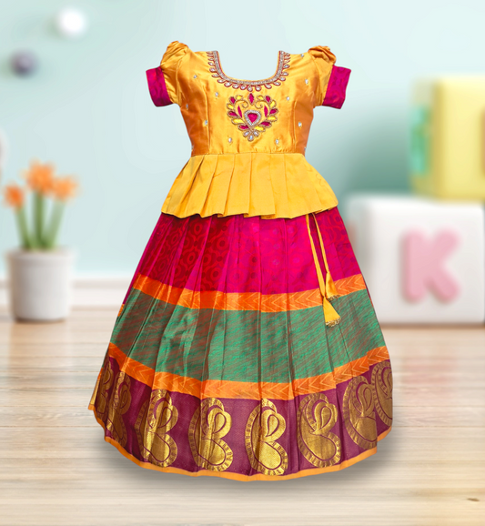 Premium pure silk pattu pavadai for girls in vibrant yellow and multicolor design with intricate Aari embroidery on blouse – traditional festive wear perfect for weddings, birthdays, temple visits, and South Indian cultural celebrations.