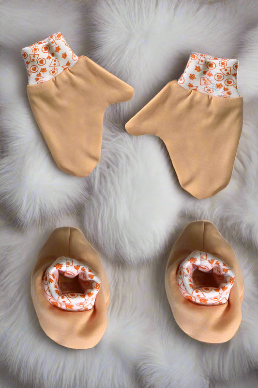 Soft cotton newborn baby mittens and booties set in Peach color for 0–6 months with printed elastic bands