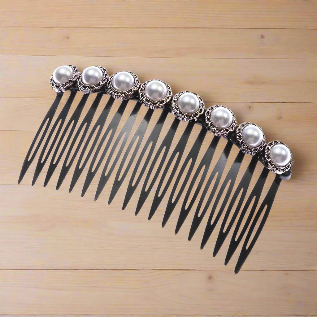 Elegant black plastic hair comb with pearl embellishments in vintage metal casing